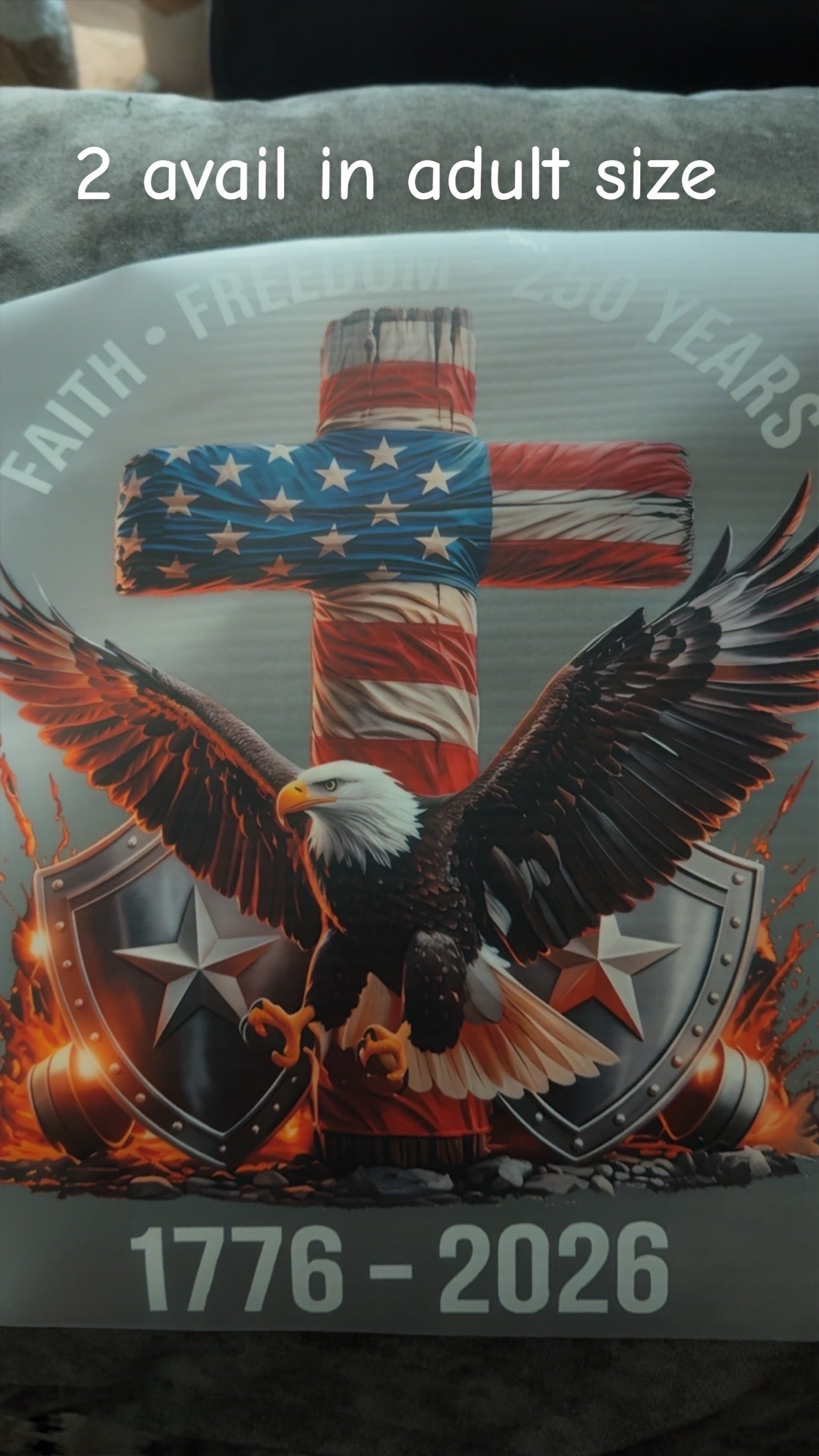 Product with American flag cross and bald eagle design, featuring text '2 avail in adult size' and '1776 - 2026'.