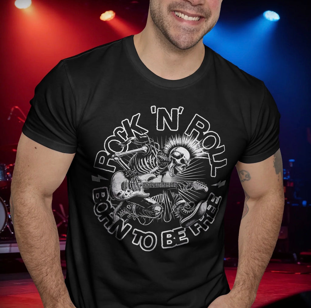 Man wearing a black t-shirt with a 'Rock 'n' Roll Born to Be Free' design in a concert setting.  avail images 4