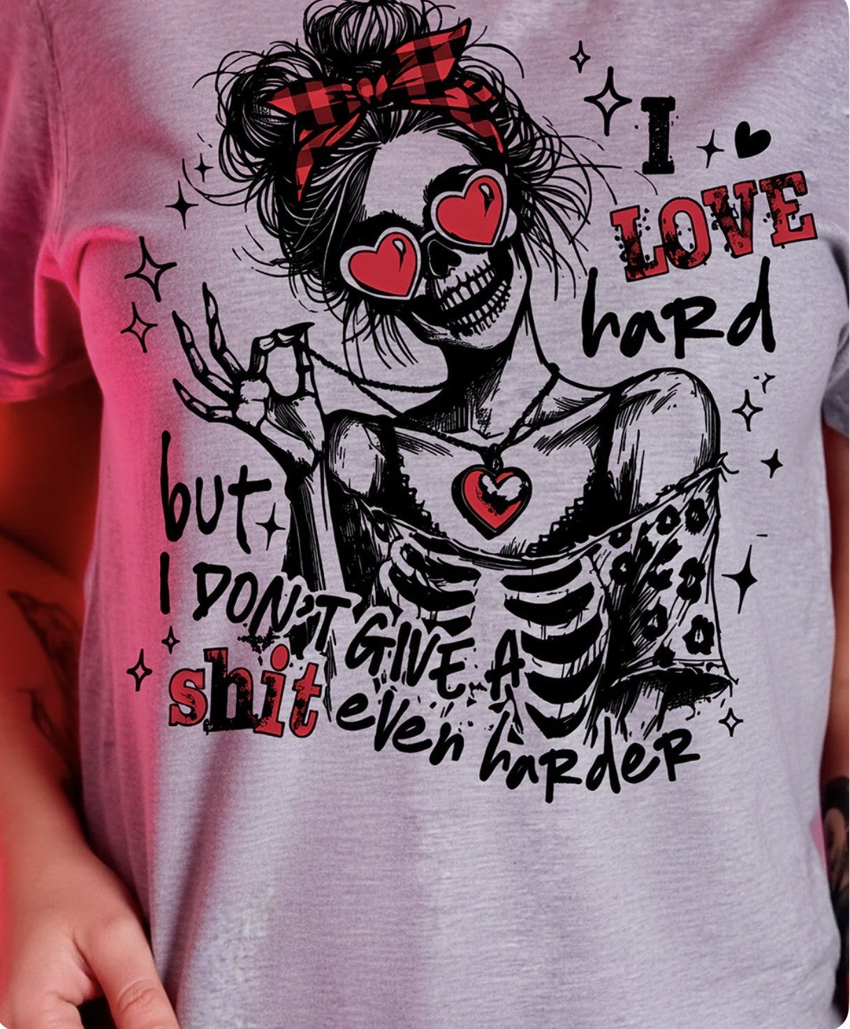Gray t-shirt with a skeleton design and text on a person wearing it.(1 avail)