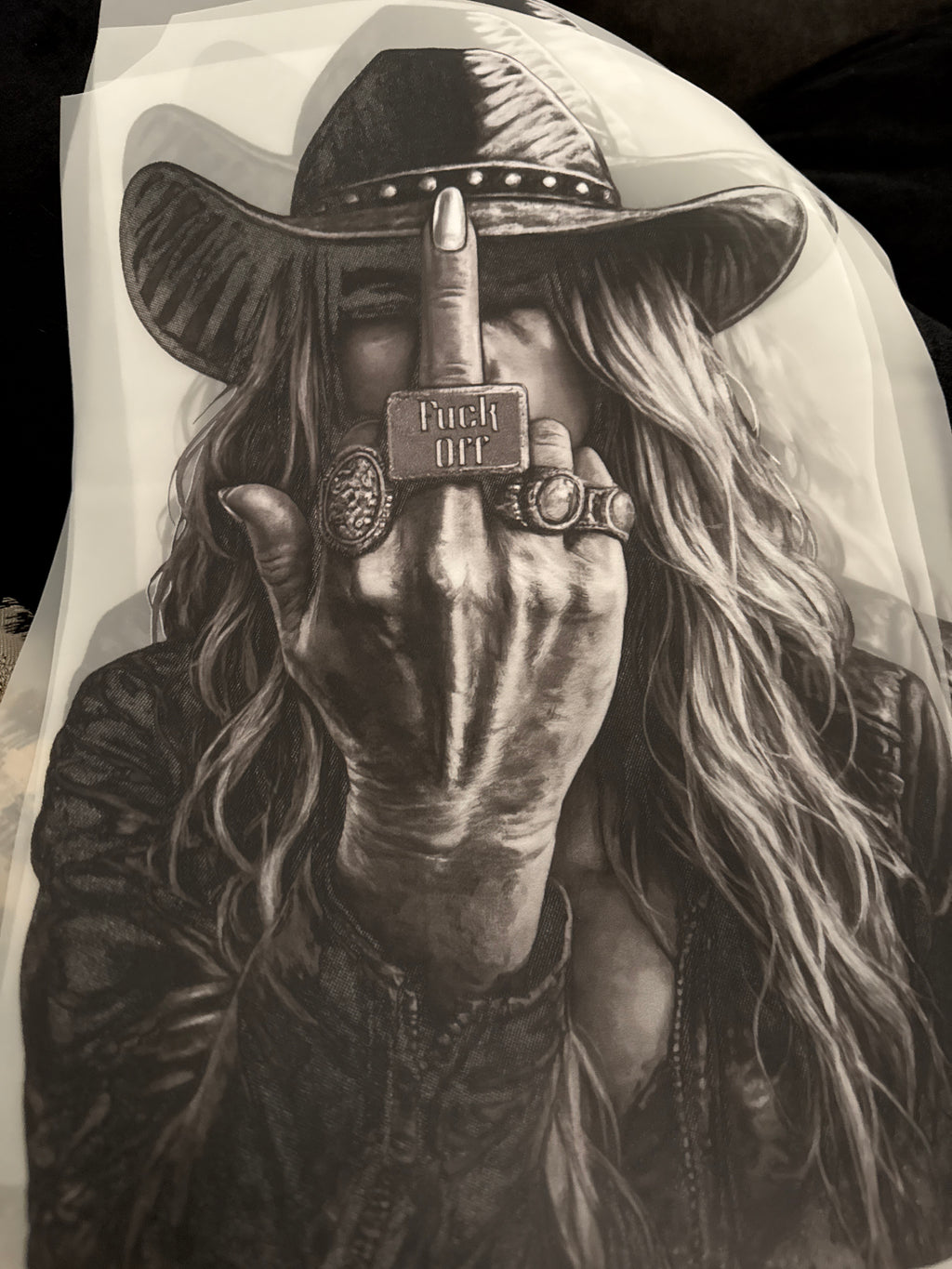 Black and white illustration of a person with long hair, wearing a hat and leather jacket, holding a bottle labeled 'Fuck You'. 3 avail